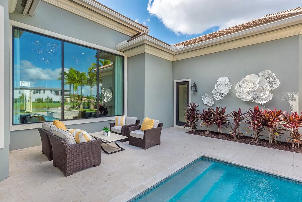 The Home in Boca Raton is a stunning transitional one story estate has Amazing custom pool with spill over spa and natural stone decking now available for sale. This home located at 17236 Brulee Breeze Way, Boca Raton, Florida