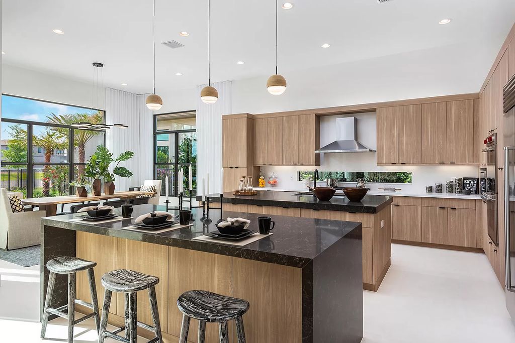 The Boca Raton Home offers a contemporary Geometric Pool with Negative Edge spa and gorgeous upgraded polished Travertine deck overlooking the lake now available for sale. This home located at 17161 Ludovica Ln, Boca Raton, Florida