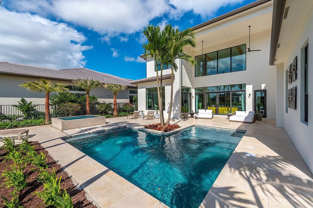 The Boca Raton Home offers a contemporary Geometric Pool with Negative Edge spa and gorgeous upgraded polished Travertine deck overlooking the lake now available for sale. This home located at 17161 Ludovica Ln, Boca Raton, Florida