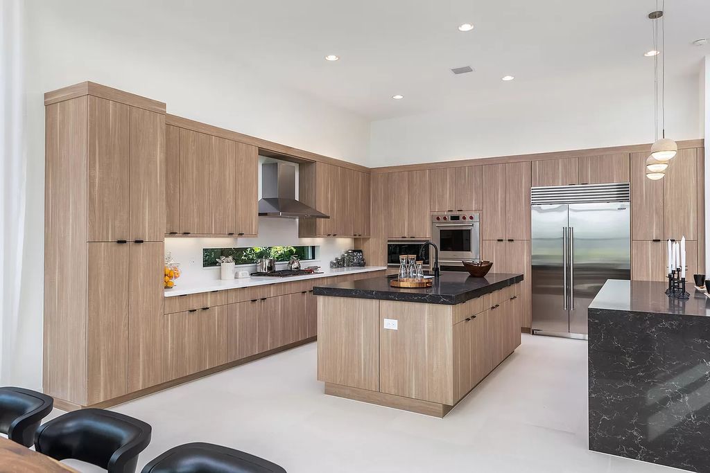 The Boca Raton Home offers a contemporary Geometric Pool with Negative Edge spa and gorgeous upgraded polished Travertine deck overlooking the lake now available for sale. This home located at 17161 Ludovica Ln, Boca Raton, Florida