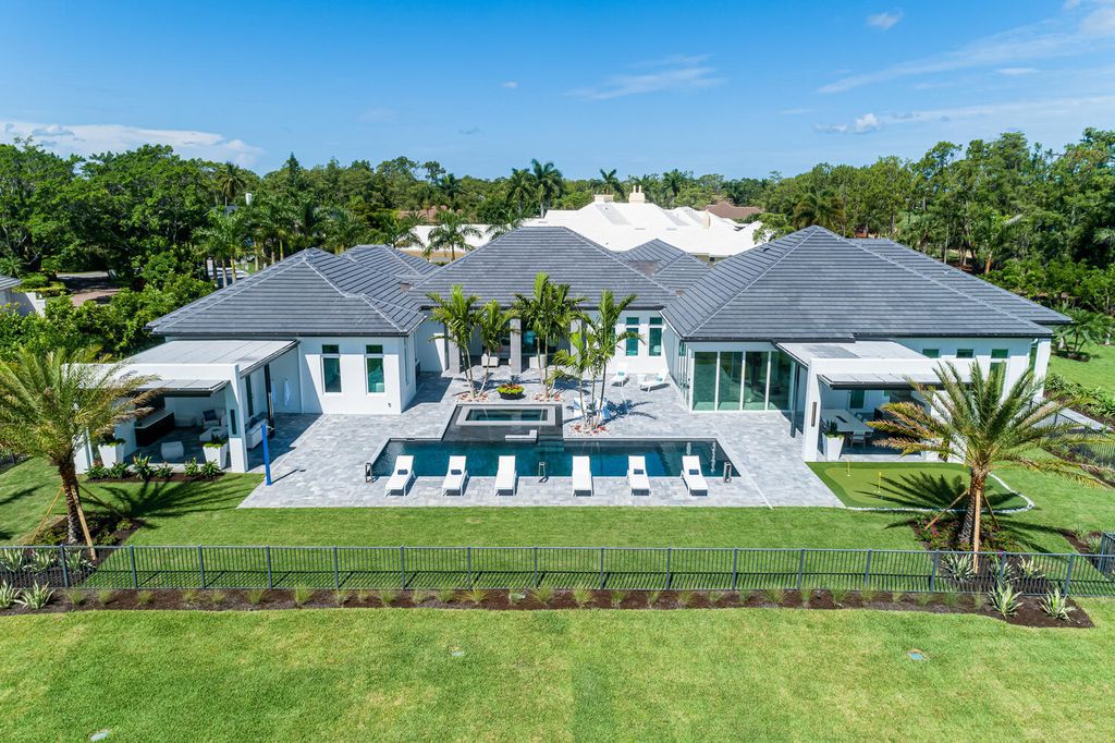 The Home in Naples is a perfect new estate expertly crafted with cutting-edge international design and mid-century modern influences now available for sale. This home located at 4445 Silver Fox Dr, Naples, Florida