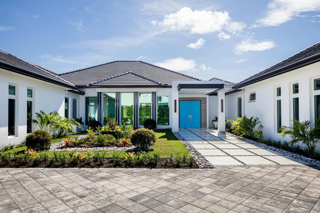The Home in Naples is a perfect new estate expertly crafted with cutting-edge international design and mid-century modern influences now available for sale. This home located at 4445 Silver Fox Dr, Naples, Florida