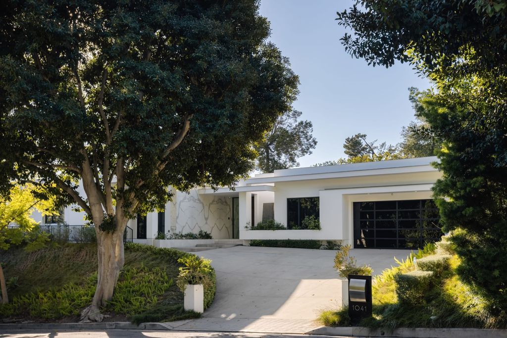 The Home in Beverly Hills is a contemporary masterpiece is built with soaring ceilings, clean lines, and sleek intricacies now available for sale. This home located at 1041 N Hillcrest Rd, Beverly Hills, California