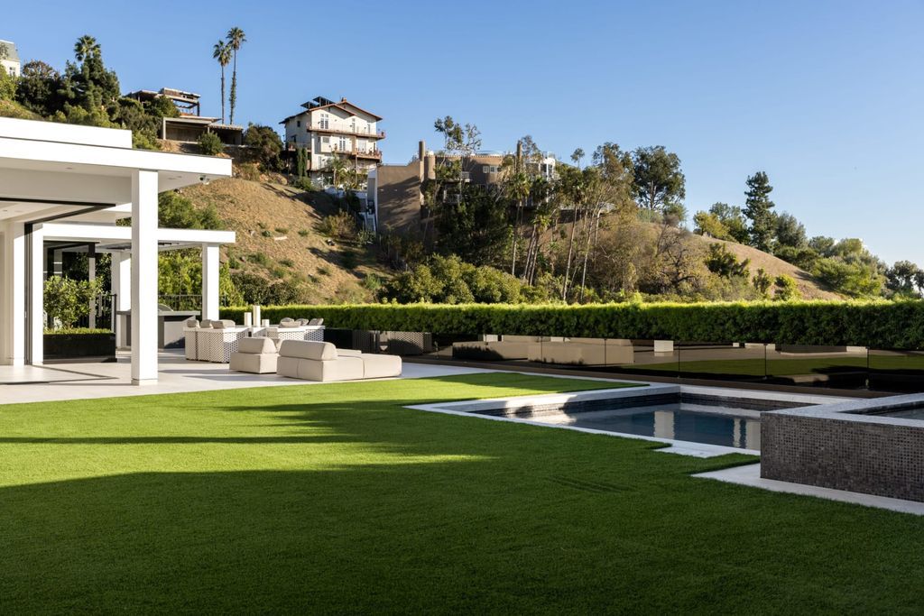 The Home in Beverly Hills is a contemporary masterpiece is built with soaring ceilings, clean lines, and sleek intricacies now available for sale. This home located at 1041 N Hillcrest Rd, Beverly Hills, California