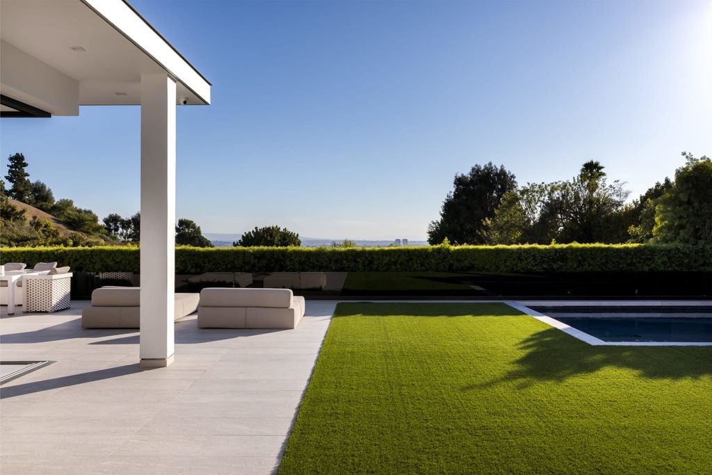 The Home in Beverly Hills is a contemporary masterpiece is built with soaring ceilings, clean lines, and sleek intricacies now available for sale. This home located at 1041 N Hillcrest Rd, Beverly Hills, California
