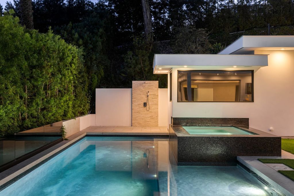 The Home in Beverly Hills is a contemporary masterpiece is built with soaring ceilings, clean lines, and sleek intricacies now available for sale. This home located at 1041 N Hillcrest Rd, Beverly Hills, California