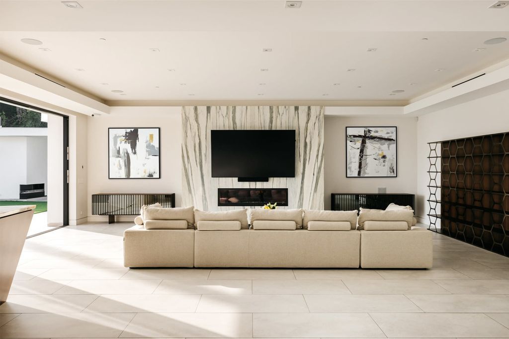 The Home in Beverly Hills is a contemporary masterpiece is built with soaring ceilings, clean lines, and sleek intricacies now available for sale. This home located at 1041 N Hillcrest Rd, Beverly Hills, California