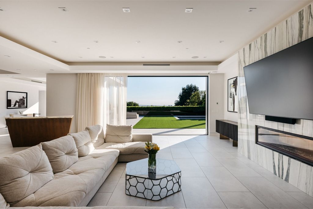 The Home in Beverly Hills is a contemporary masterpiece is built with soaring ceilings, clean lines, and sleek intricacies now available for sale. This home located at 1041 N Hillcrest Rd, Beverly Hills, California