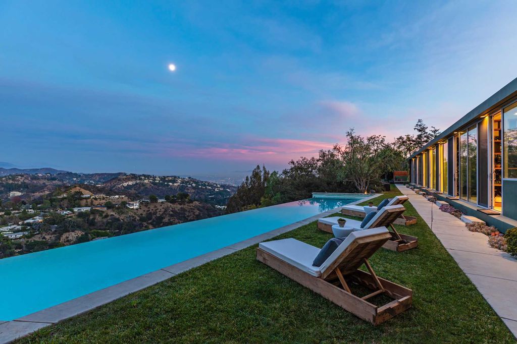 The Los Angeles Home is a hilltop sanctuary nestled on 1.5 picturesque acres perched above Laurel Canyon and built by AIA award-winning architect Hagy Belzberg now available for sale. This home located at 8520 Skyline Dr, Los Angeles, California