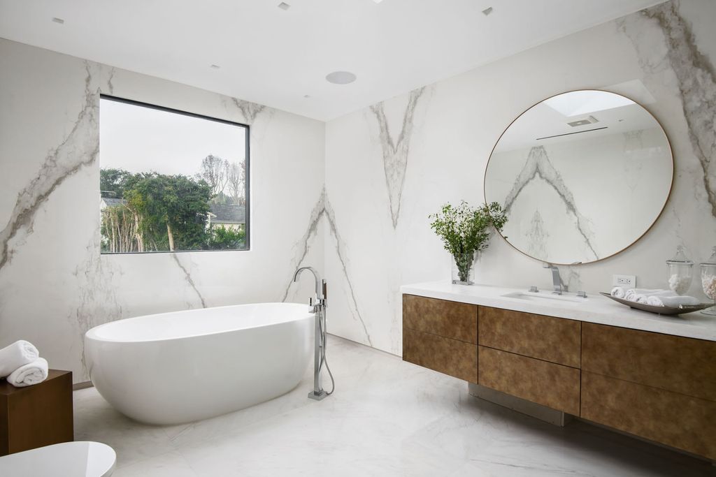 The Home in Beverly Hills is a contemporary new-build, designed by Gabbay Architects is sited behind mature olive trees now available for sale. This home located at 1729 Angelo Dr, Beverly Hills, California