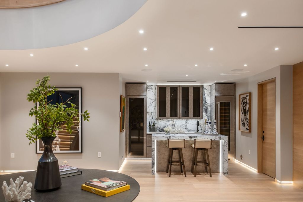 The Home in Beverly Hills is a contemporary new-build, designed by Gabbay Architects is sited behind mature olive trees now available for sale. This home located at 1729 Angelo Dr, Beverly Hills, California