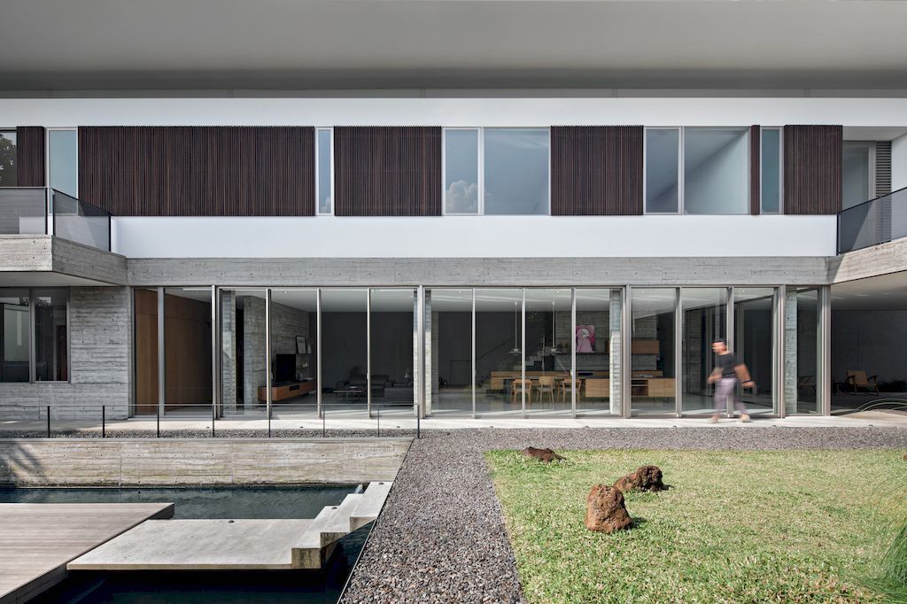 Hover House with rustic & brutal of concrete Design by Pranala Associates