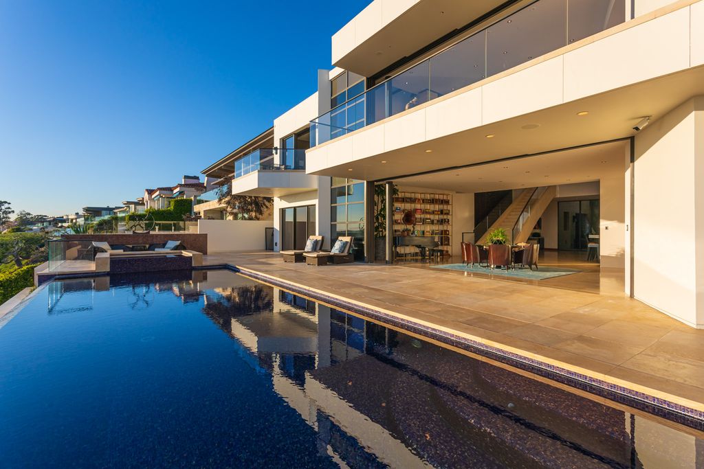 The Home in Corona Del Mar is an unparalleled design and unrivaled construction quality with explosive front-row panoramic views now available for sale. This house located at 1301 Dolphin Ter, Corona Del Mar, California