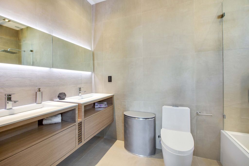 The Miami Beach Home is a new construction home located on a quiet street with direct access to the prestigious La Gorce Country Club now available for sale. This house located at 450 W 62nd St, Miami Beach, Florida