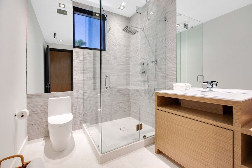 The Miami Beach Home is a new construction home located on a quiet street with direct access to the prestigious La Gorce Country Club now available for sale. This house located at 450 W 62nd St, Miami Beach, Florida