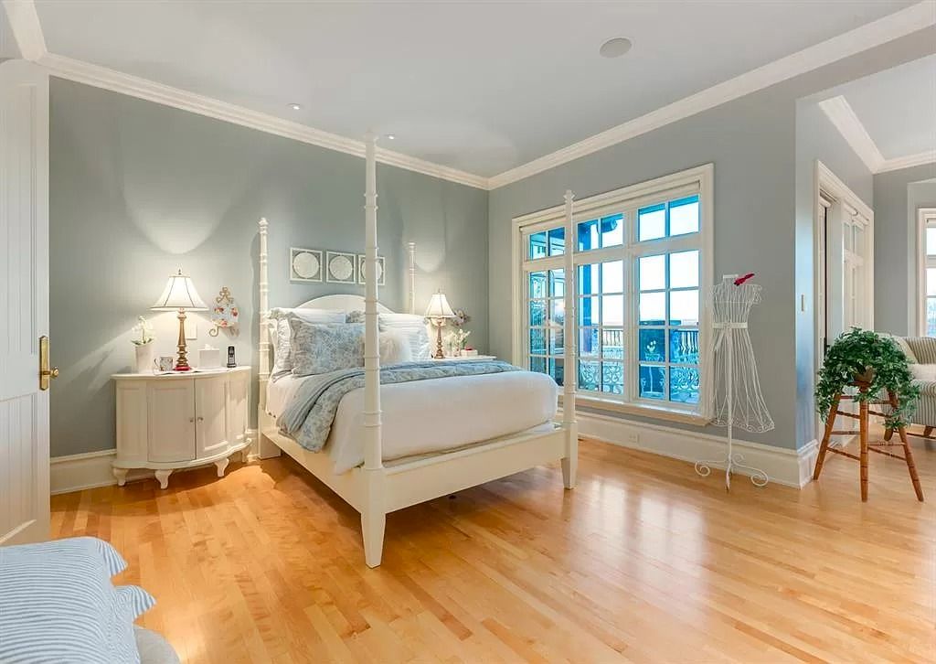 The Magnificent Home in Alberta features extensive hand-hewn grey Canmore limestone, soaring peaks, arched windows, and a majestic sloped roof now available for sale
