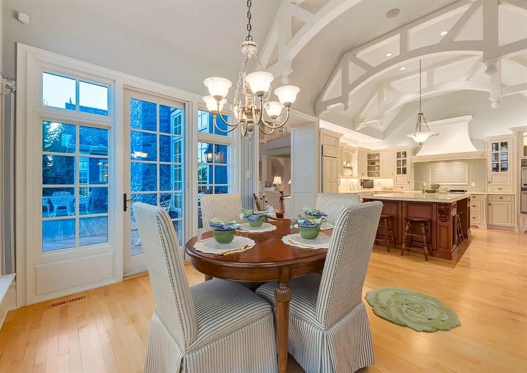 The Magnificent Home in Alberta features extensive hand-hewn grey Canmore limestone, soaring peaks, arched windows, and a majestic sloped roof now available for sale