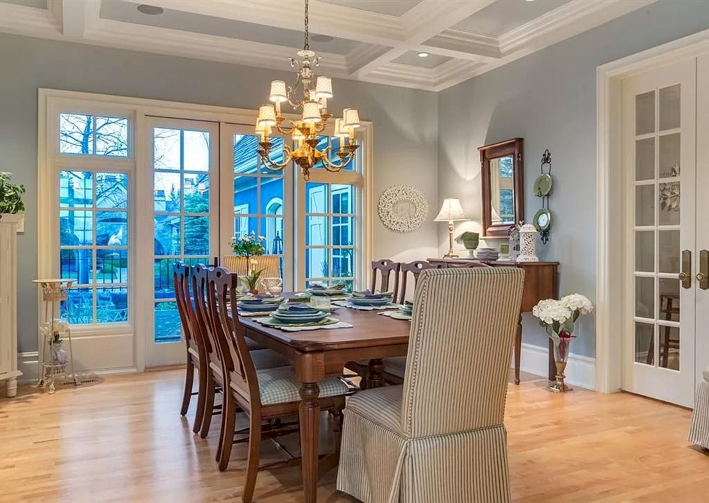 The Magnificent Home in Alberta features extensive hand-hewn grey Canmore limestone, soaring peaks, arched windows, and a majestic sloped roof now available for sale