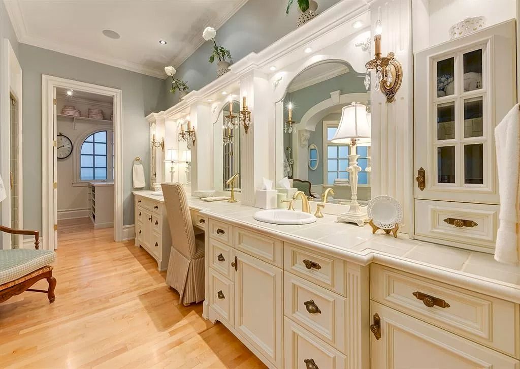 The Magnificent Home in Alberta features extensive hand-hewn grey Canmore limestone, soaring peaks, arched windows, and a majestic sloped roof now available for sale