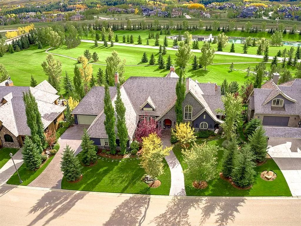 The Magnificent Home in Alberta features extensive hand-hewn grey Canmore limestone, soaring peaks, arched windows, and a majestic sloped roof now available for sale