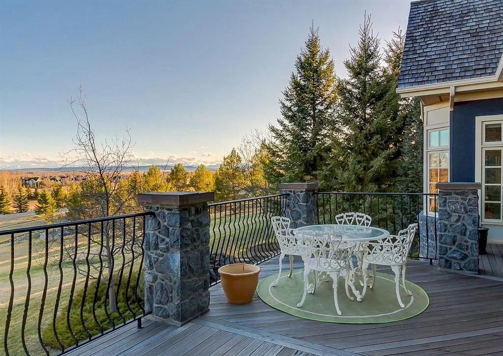 The Magnificent Home in Alberta features extensive hand-hewn grey Canmore limestone, soaring peaks, arched windows, and a majestic sloped roof now available for sale