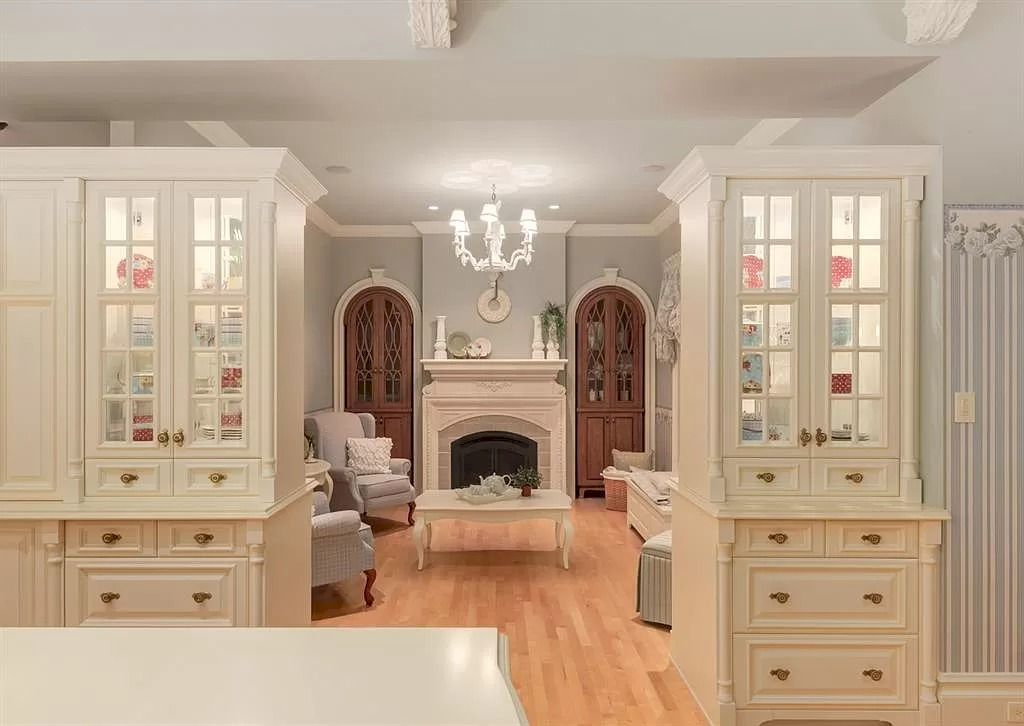The Magnificent Home in Alberta features extensive hand-hewn grey Canmore limestone, soaring peaks, arched windows, and a majestic sloped roof now available for sale