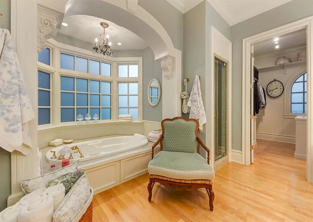 The Magnificent Home in Alberta features extensive hand-hewn grey Canmore limestone, soaring peaks, arched windows, and a majestic sloped roof now available for sale