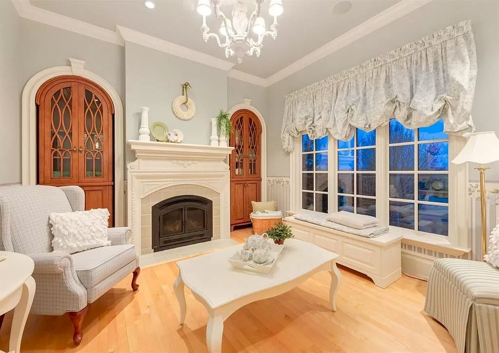 The Magnificent Home in Alberta features extensive hand-hewn grey Canmore limestone, soaring peaks, arched windows, and a majestic sloped roof now available for sale
