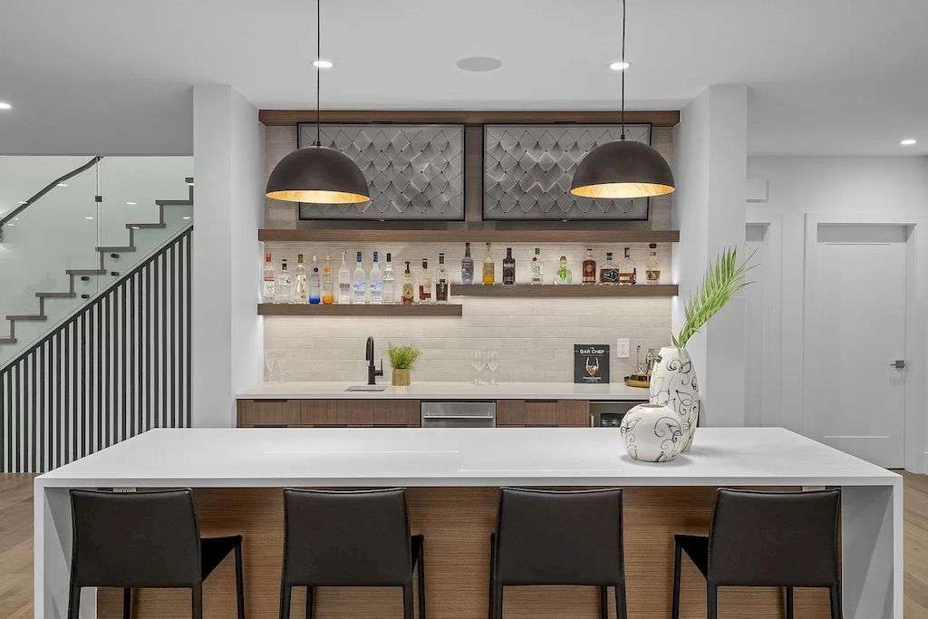 Wall-mounted shelves are also an effective idea to utilize small, empty wall spaces that are insufficient for installation or storage of any kitchen accessories and utensils. As seen in the DIY kitchen above, two wooden wall-mounted shelves are installed above the narrow space above the sink, creating a home bar area. You don't need to go far to enjoy a few weekend alcohol shots.