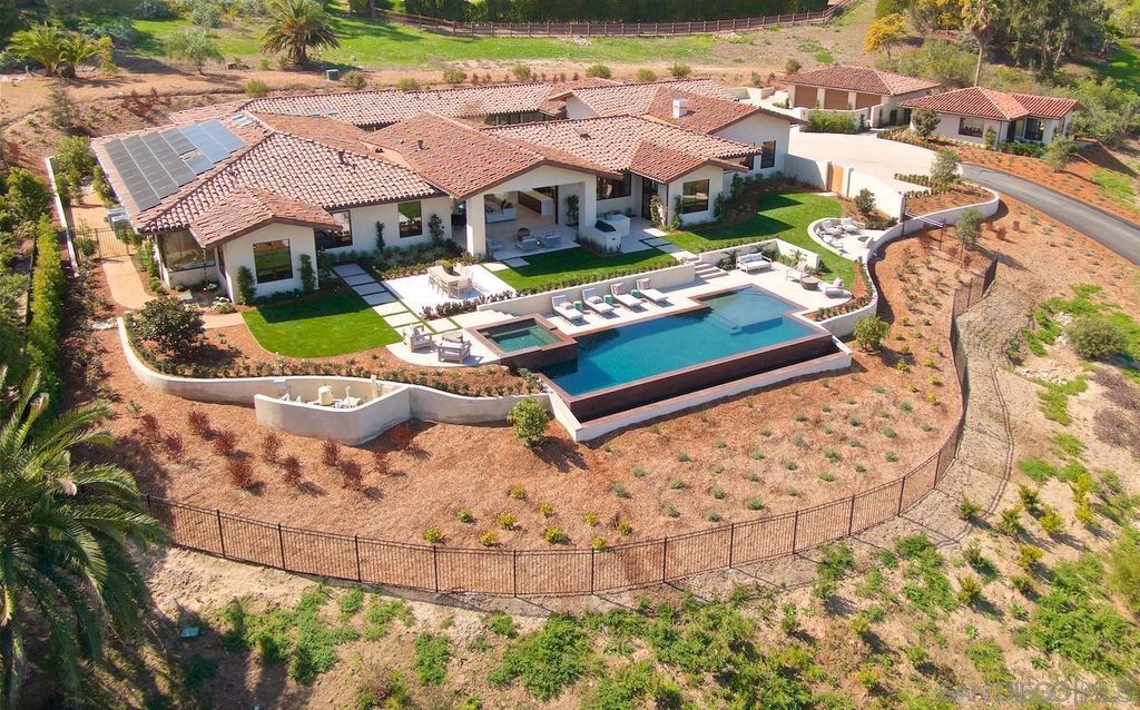 The Home in Rancho Santa Fe is an exquisite luxury oasis conceived by top team builder & design visionaries offering incomparable unobstructed views now available for sale. This house located at 18080 Via De Fortuna, Rancho Santa Fe, California