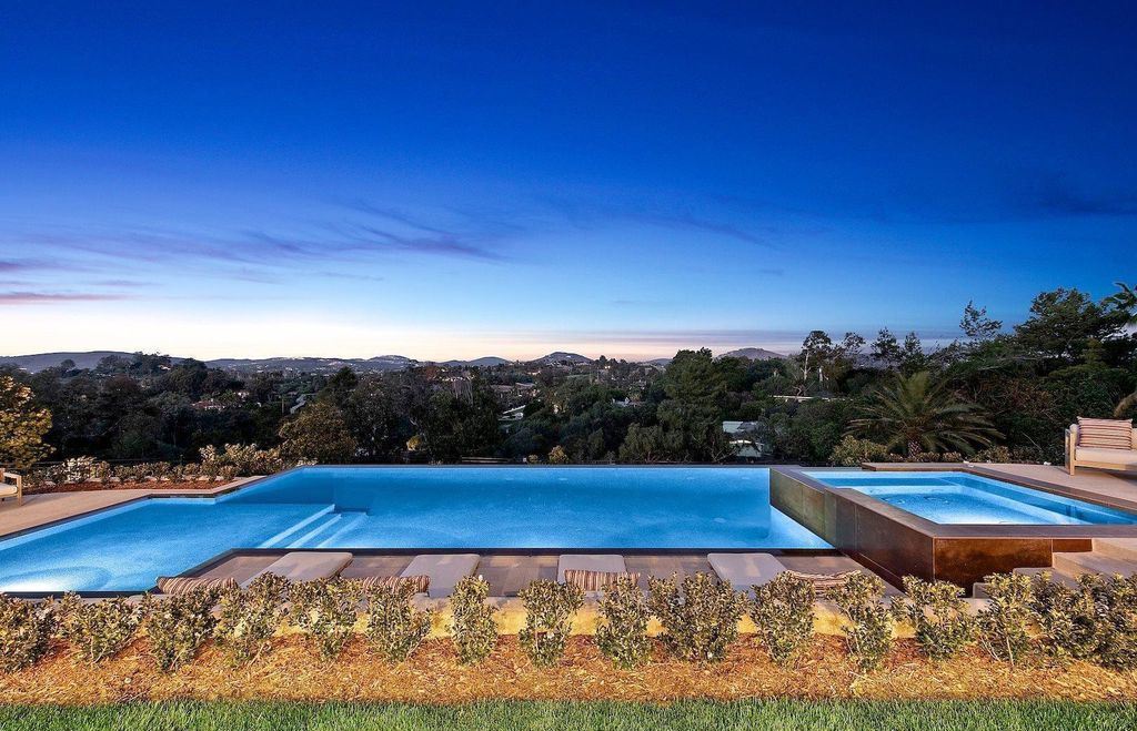 The Home in Rancho Santa Fe is an exquisite luxury oasis conceived by top team builder & design visionaries offering incomparable unobstructed views now available for sale. This house located at 18080 Via De Fortuna, Rancho Santa Fe, California