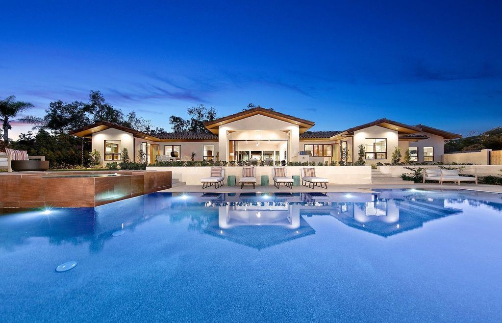 The Home in Rancho Santa Fe is an exquisite luxury oasis conceived by top team builder & design visionaries offering incomparable unobstructed views now available for sale. This house located at 18080 Via De Fortuna, Rancho Santa Fe, California