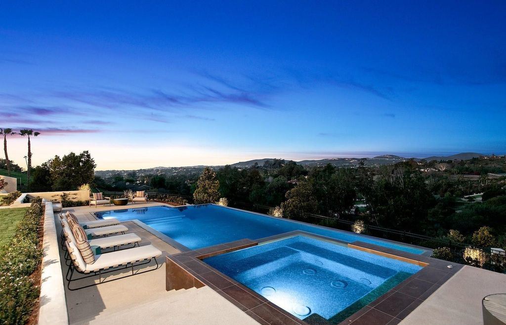 The Home in Rancho Santa Fe is an exquisite luxury oasis conceived by top team builder & design visionaries offering incomparable unobstructed views now available for sale. This house located at 18080 Via De Fortuna, Rancho Santa Fe, California