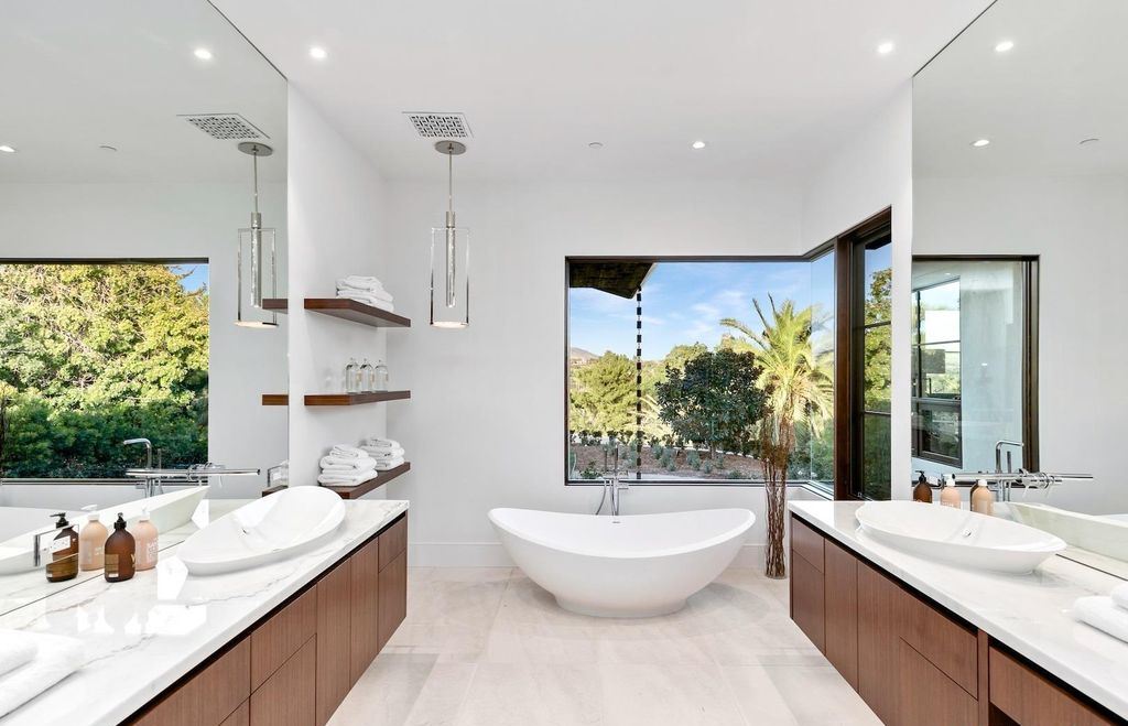 The Home in Rancho Santa Fe is an exquisite luxury oasis conceived by top team builder & design visionaries offering incomparable unobstructed views now available for sale. This house located at 18080 Via De Fortuna, Rancho Santa Fe, California