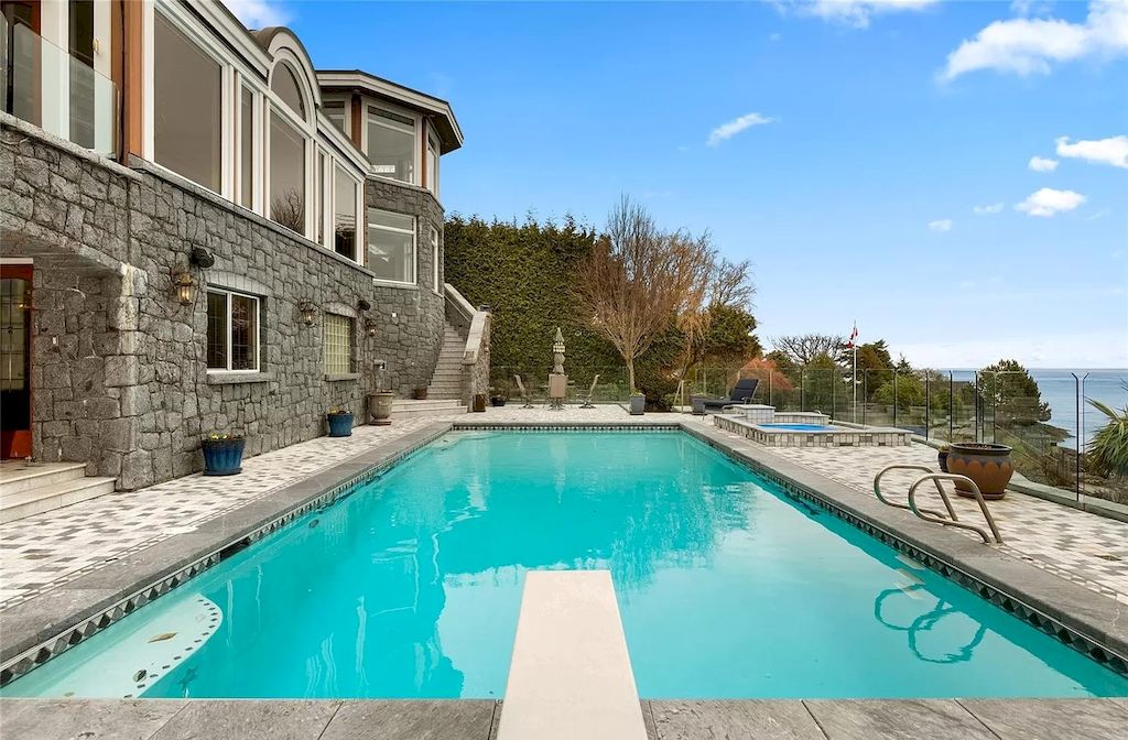 The House in Oak Bay is entertainment haven complete with resort style living with a pool, hot tub, expansive patio sections including covered sections & oceanfront setting with beach access now available for sale