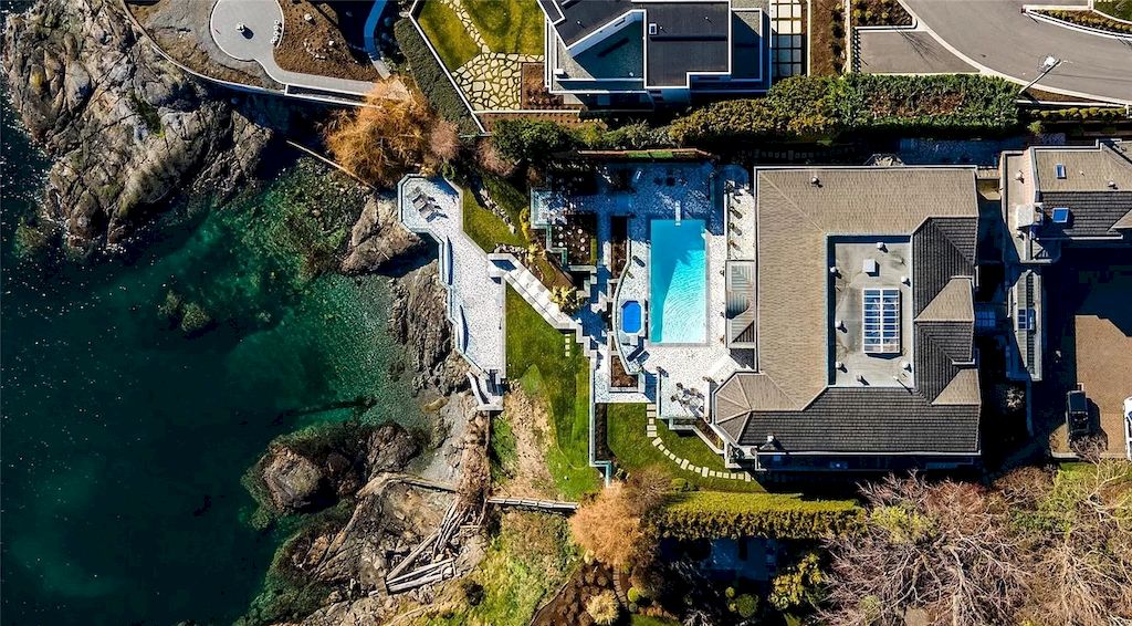 The House in Oak Bay is entertainment haven complete with resort style living with a pool, hot tub, expansive patio sections including covered sections & oceanfront setting with beach access now available for sale