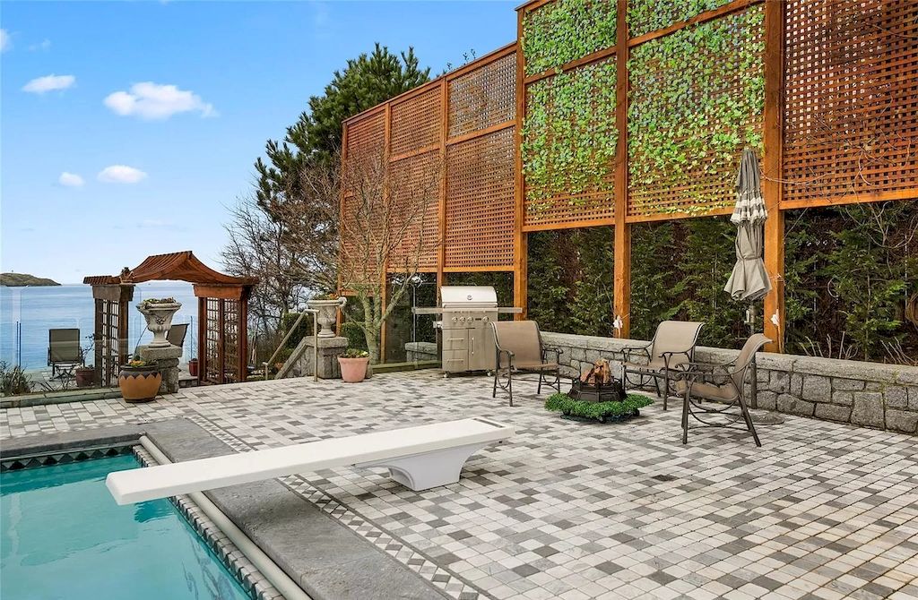 The House in Oak Bay is entertainment haven complete with resort style living with a pool, hot tub, expansive patio sections including covered sections & oceanfront setting with beach access now available for sale