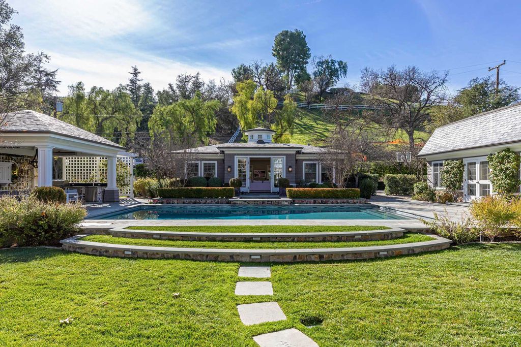 The Home in Hidden Hills is a stunning Dutch Colonial with outdoor kitchen make for the ultimate in estate living now available for sale. This home located at 23870 Long Valley Rd, Hidden Hills, California;