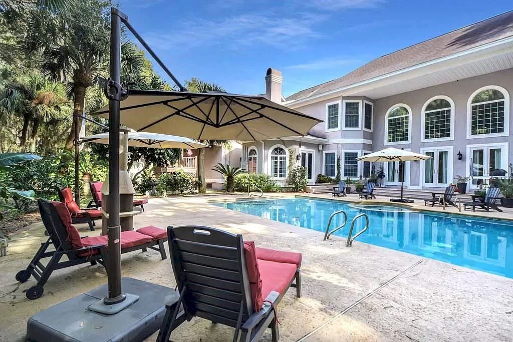 The Home in Georgia is a luxurious home offering impressive foyer, gracious living room and spacious dining room now available for sale. This home located at 23 Carriage Dr, Saint Simons Island, Georgia; offering 07 bedrooms and 08 bathrooms with 10,688 square feet of living spaces.