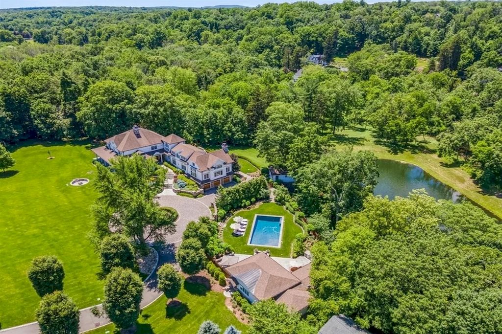 The Home in New Jersey is a luxurious farmhouse compounds featuring soaring ceilings, glass walls, a beautiful pool, a gallery and more now available for sale. This home located at 255 E Saddle River Rd, Saddle River, New Jersey; offering 06 bedrooms and 07 bathrooms with approximately 10 acres of land.
