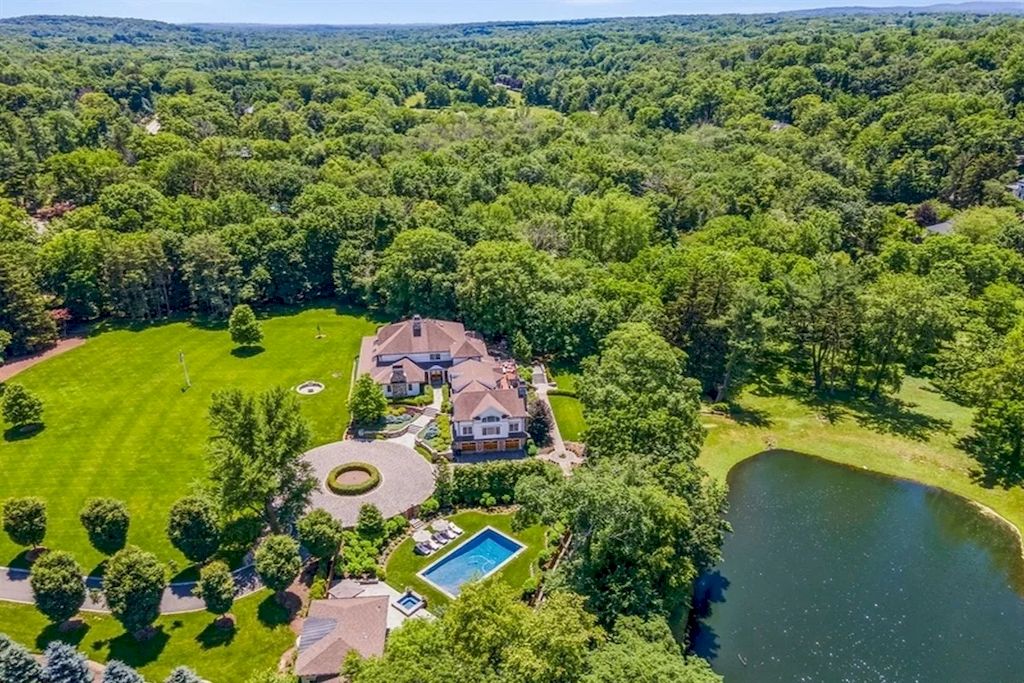 The Home in New Jersey is a luxurious farmhouse compounds featuring soaring ceilings, glass walls, a beautiful pool, a gallery and more now available for sale. This home located at 255 E Saddle River Rd, Saddle River, New Jersey; offering 06 bedrooms and 07 bathrooms with approximately 10 acres of land.