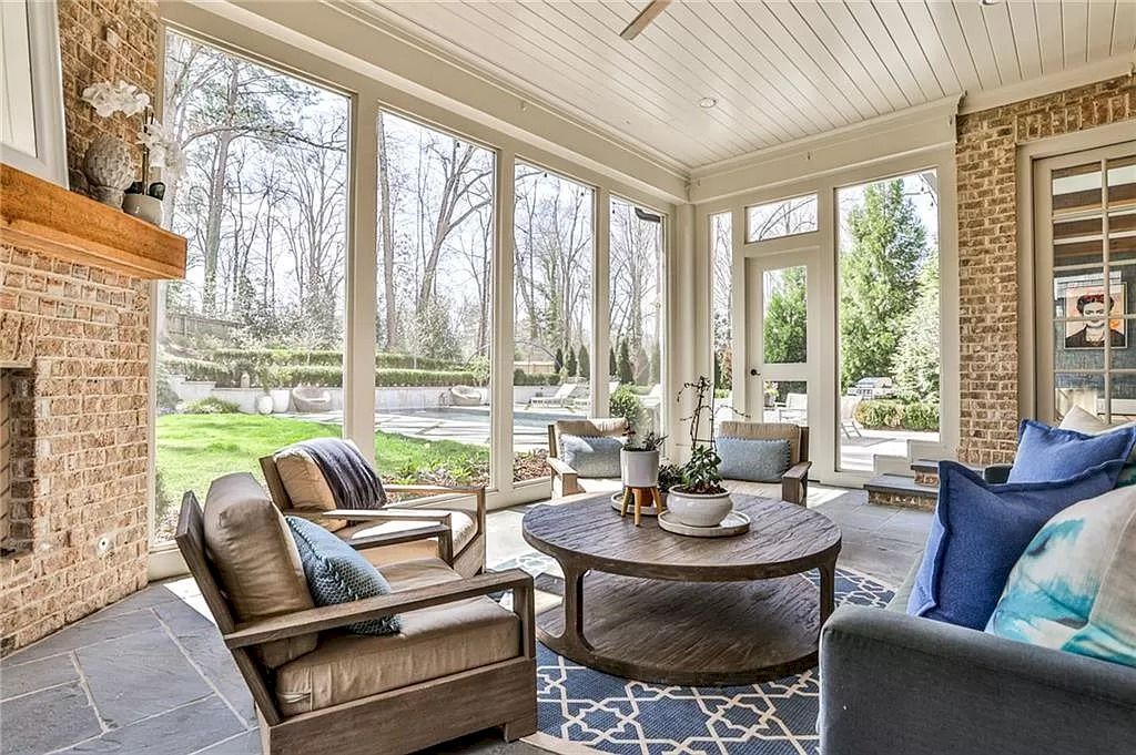 Intricate wood detailing, like this wooden set of sofa and tea table, makes a living space feel particularly in sync with nature. More than that, the stone wall and floors make this living room more rustic than ever.