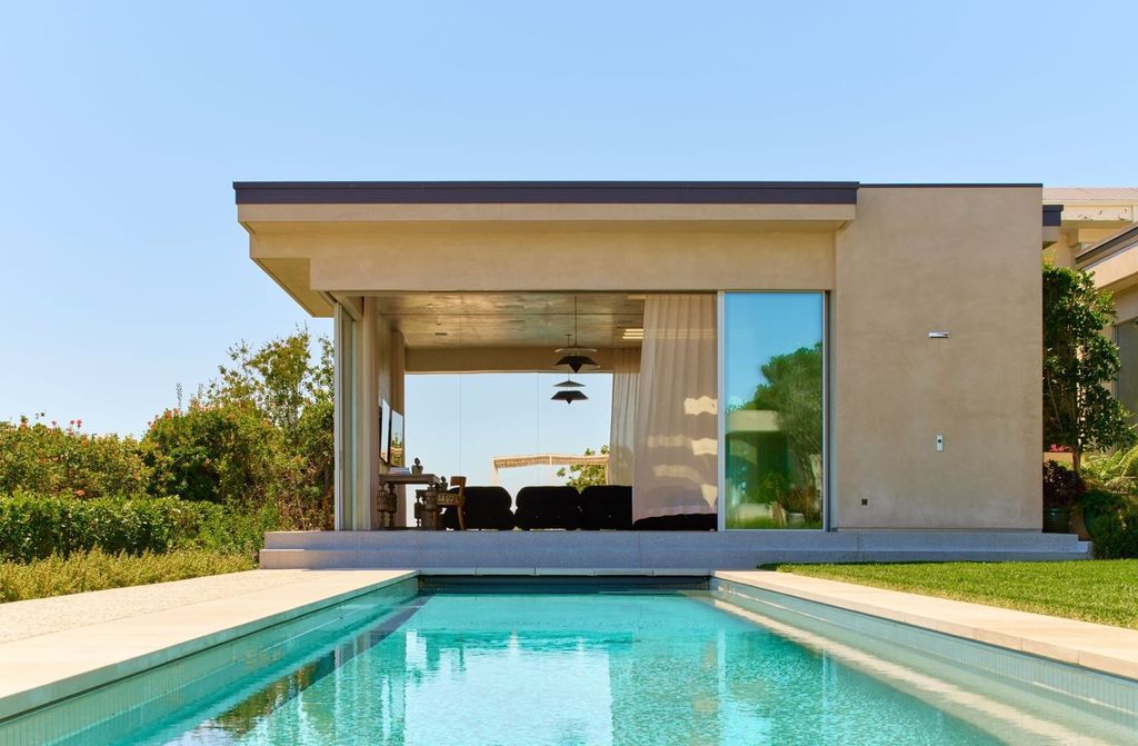 The Mansion in Los Angeles is a contemporary masterpiece with impressive views, inspired design, and a serenely secluded location with gated access now available for sale. This home located at 335 Trousdale Pl, Beverly Hills, California