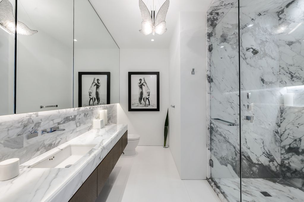 The Mansion in Miami Beach is a luxurious retreat-inspired custom built residence provides a zen ambiance with floating orchid gardens now available for sale. This home located at 4395 Pine Tree Dr, Miami Beach, Florida