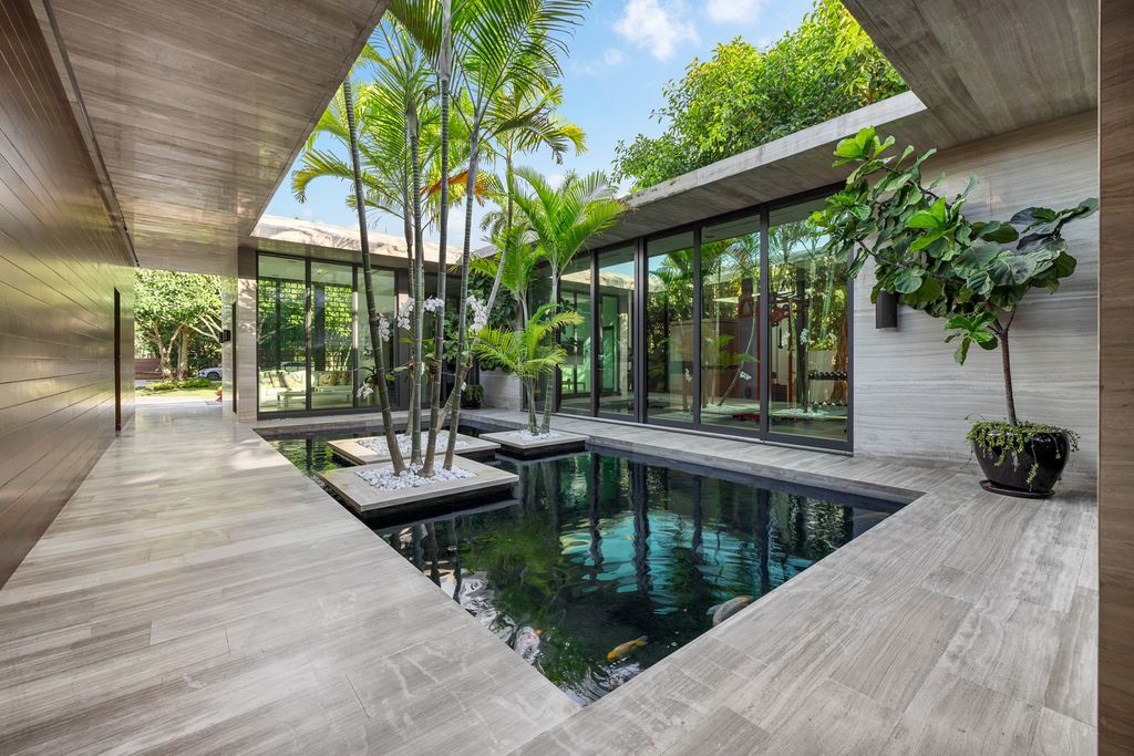 The Mansion in Miami Beach is a luxurious retreat-inspired custom built residence provides a zen ambiance with floating orchid gardens now available for sale. This home located at 4395 Pine Tree Dr, Miami Beach, Florida