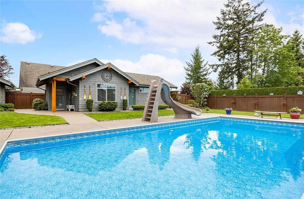 The Home in Parksville is majestically set on 0.64 of an acre with a private path that leads to the beach living space below, now available for sale. This home located at 798 Fairwind Ave, Parksville, BC V9P 1B2, Canada