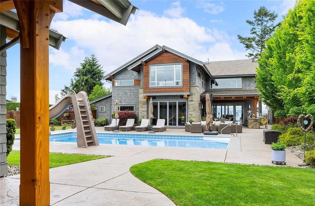 The Home in Parksville is majestically set on 0.64 of an acre with a private path that leads to the beach living space below, now available for sale. This home located at 798 Fairwind Ave, Parksville, BC V9P 1B2, Canada