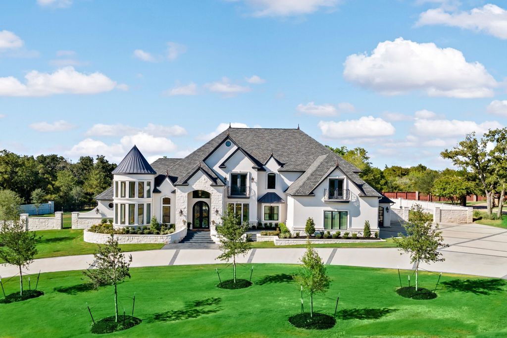 The Home in Bryan, a luxurious custom residence has a open concept great room complete with 20-foot ceilings, a beautifully designed pool and elegant outdoor entertaining area. This home located at 7163 Riverstone Dr, Bryan, Texas.