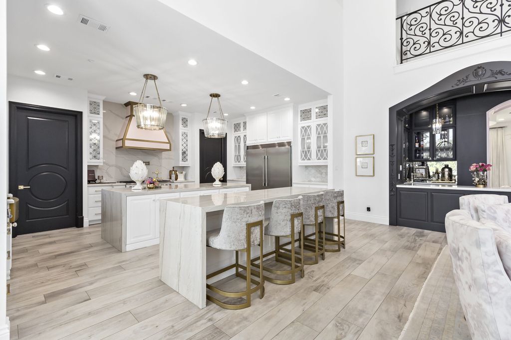 The Home in Bryan, a luxurious custom residence has a open concept great room complete with 20-foot ceilings, a beautifully designed pool and elegant outdoor entertaining area. This home located at 7163 Riverstone Dr, Bryan, Texas.
