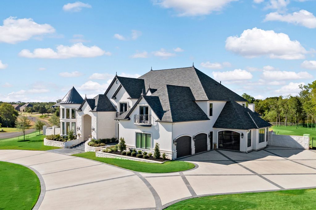 The Home in Bryan, a luxurious custom residence has a open concept great room complete with 20-foot ceilings, a beautifully designed pool and elegant outdoor entertaining area. This home located at 7163 Riverstone Dr, Bryan, Texas.